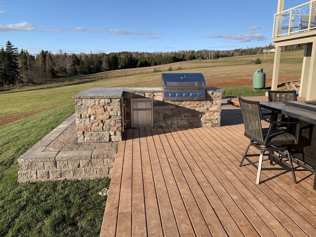 Natural stone outdoor kitchen built by DinoMac Masonry