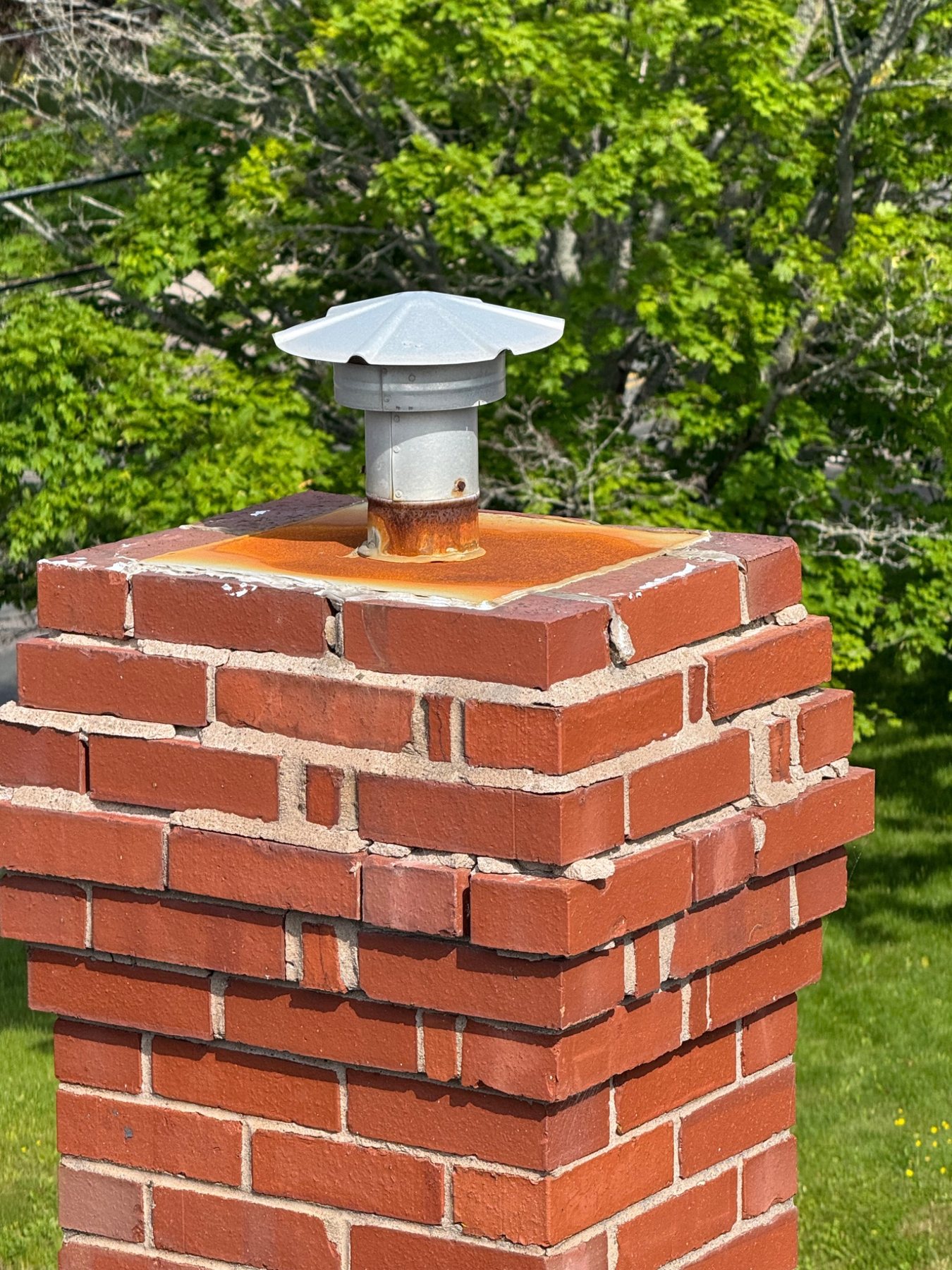 Masonry chimney crown and cap showing the top water-shedding components