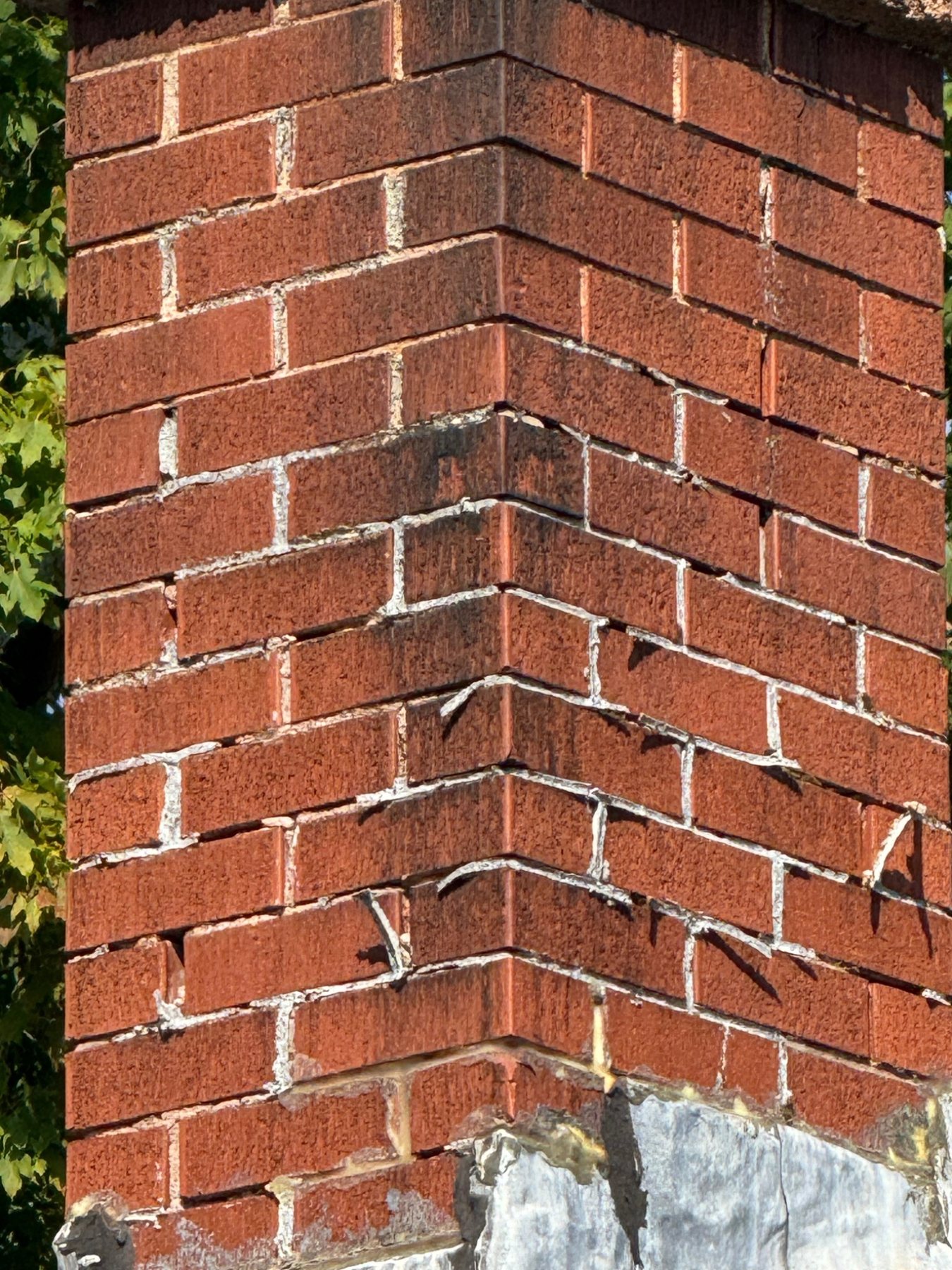 Masonry chimney with course movement and cracking