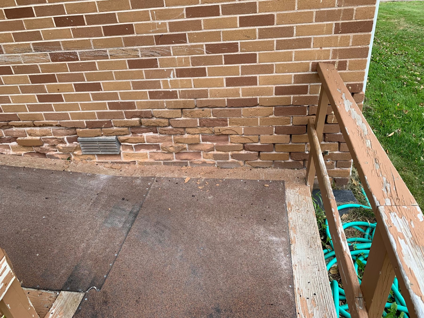 Brick wall with spalling and loss of the fired face near the lower wall