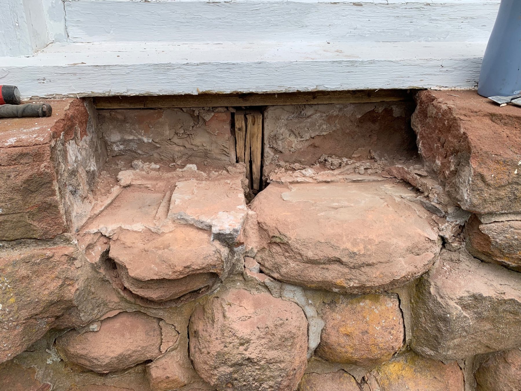 Old stone foundation bearing transition where support conditions require careful assessment