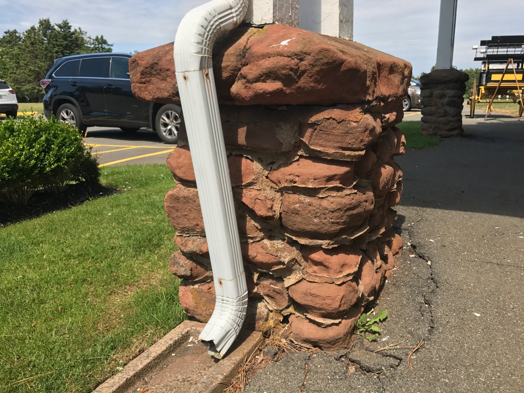 Downspout discharging close to a masonry foundation