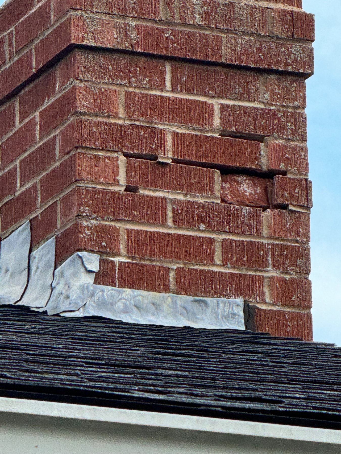Loose and displaced chimney brick showing a condition that can become a safety concern